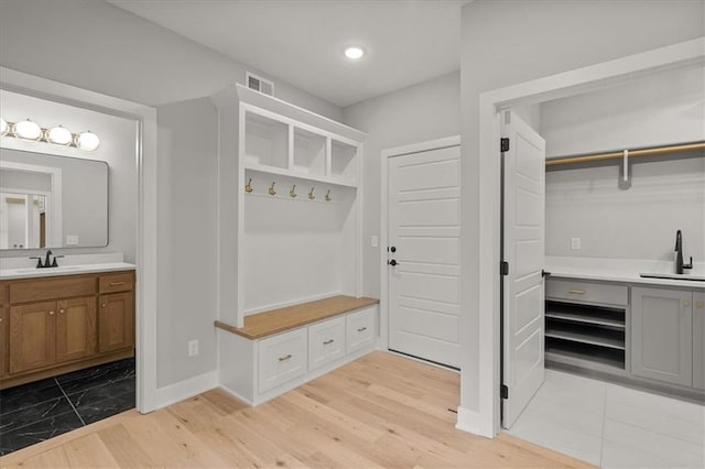 8732 N Lewis Ave, Kansas City, MO 64157 - mudroom with a sink, light wood-style floors, baseboards, and recessed lighting