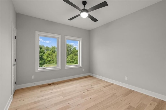 8732 N Lewis Ave, Kansas City, MO 64157 - unfurnished room with light wood-style flooring, baseboards, and a ceiling fan