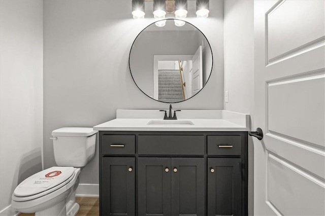 8732 N Lewis Ave, Kansas City, MO 64157 - half bathroom featuring toilet, vanity, and baseboards