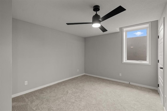 8732 N Lewis Ave, Kansas City, MO 64157 - carpeted spare room featuring a ceiling fan and baseboards