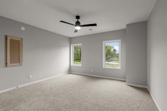 8732 N Lewis Ave, Kansas City, MO 64157 - unfurnished room featuring light carpet, baseboards, and a ceiling fan