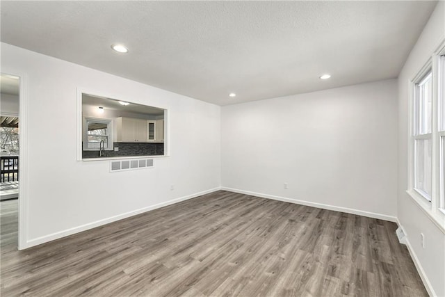 spare room with wood-type flooring