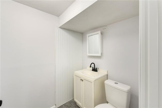 bathroom with vanity, hardwood / wood-style floors, and toilet