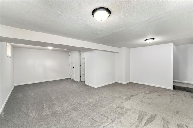 basement with carpet floors and a textured ceiling