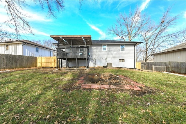 back of property with a lawn, central air condition unit, and a deck