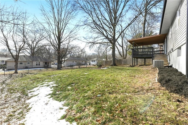 view of yard with a wooden deck and central air condition unit