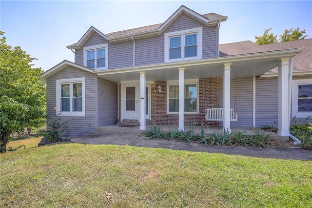 view of front of home with covered porch and a front yard