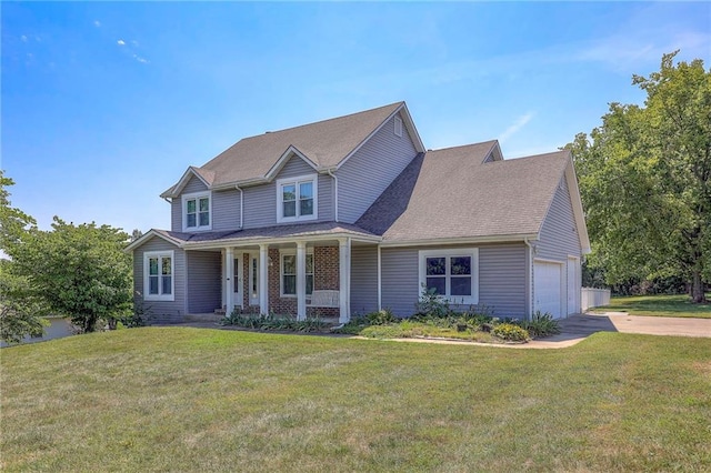 view of front of property with a garage, covered porch, and a front lawn