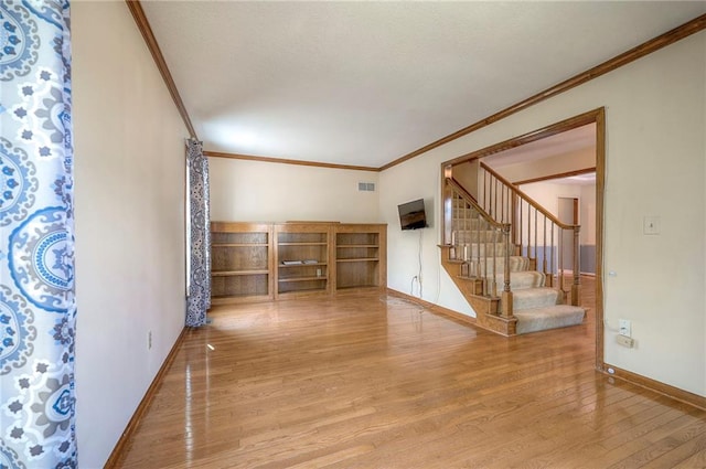 interior space featuring crown molding and hardwood / wood-style floors