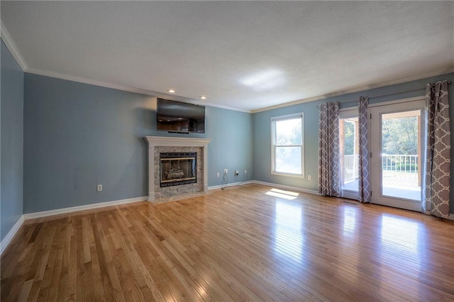 unfurnished living room featuring ornamental molding and light wood-type flooring