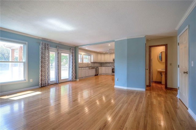 unfurnished living room with light hardwood / wood-style floors, a textured ceiling, and ornamental molding