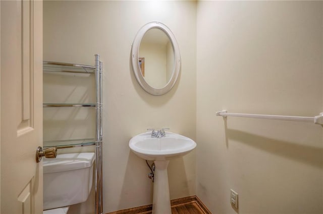 bathroom with toilet and hardwood / wood-style flooring