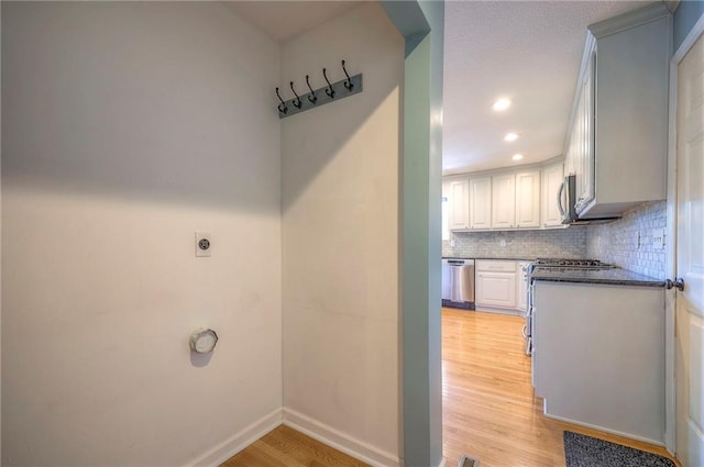 laundry area featuring light hardwood / wood-style floors and electric dryer hookup