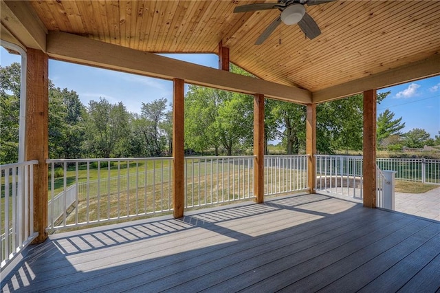 unfurnished sunroom with a water view, lofted ceiling, ceiling fan, and wood ceiling