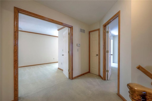 hallway with light colored carpet