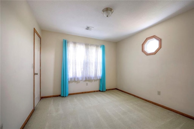 carpeted empty room featuring a wealth of natural light