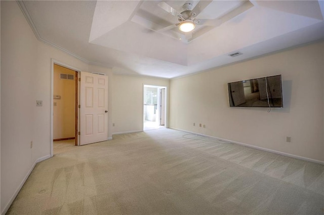 carpeted empty room featuring crown molding, ceiling fan, and a tray ceiling