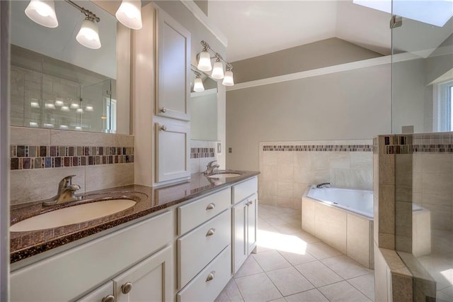 bathroom featuring vanity, lofted ceiling with skylight, separate shower and tub, tile walls, and tile patterned floors