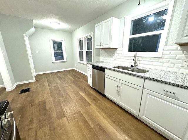 kitchen featuring light wood-type flooring, sink, tasteful backsplash, and dishwasher