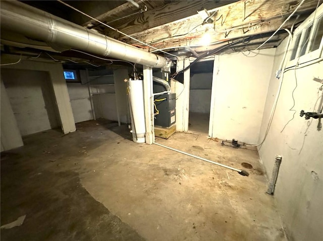 basement featuring heating unit and water heater