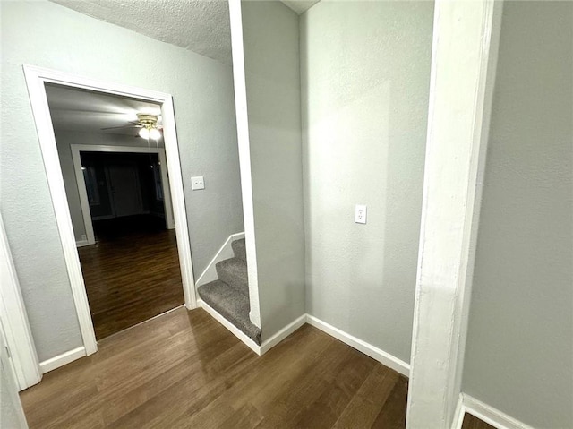 hall featuring a textured ceiling and wood-type flooring