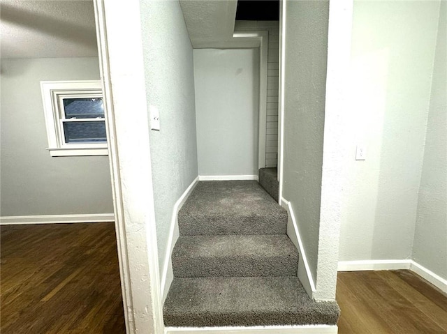 stairs featuring hardwood / wood-style floors