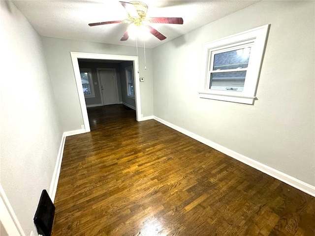 unfurnished room featuring ceiling fan and dark hardwood / wood-style floors