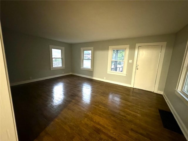 spare room featuring dark hardwood / wood-style floors