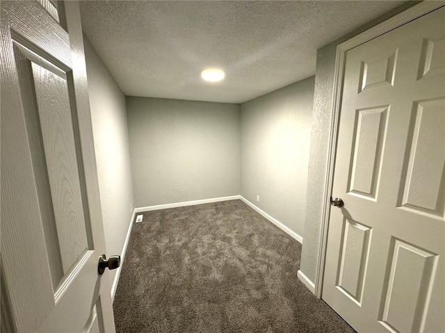 carpeted spare room with a textured ceiling