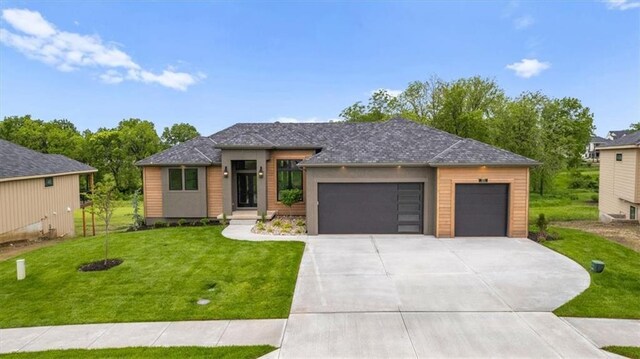 8720 N Lewis Ave, Kansas City, MO 64157 - prairie-style house featuring an attached garage, a front yard, and driveway