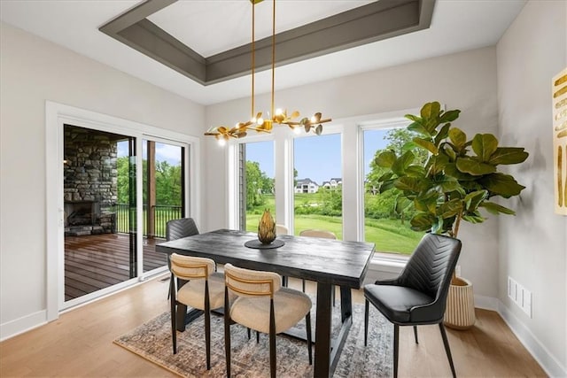 8720 N Lewis Ave, Kansas City, MO 64157 - dining area with a chandelier, plenty of natural light, light wood finished floors, and baseboards