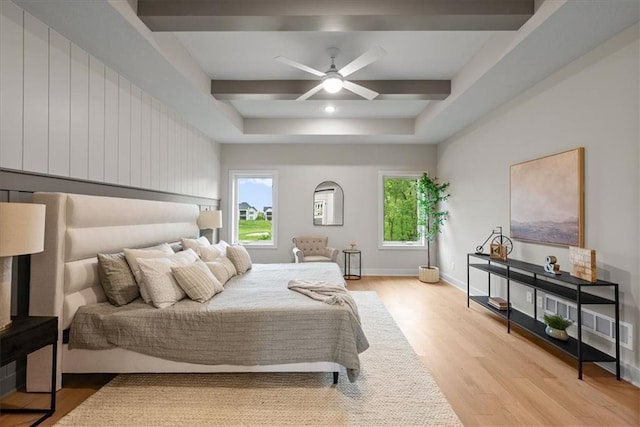 8720 N Lewis Ave, Kansas City, MO 64157 - bedroom with light wood-style flooring, multiple windows, and a tray ceiling