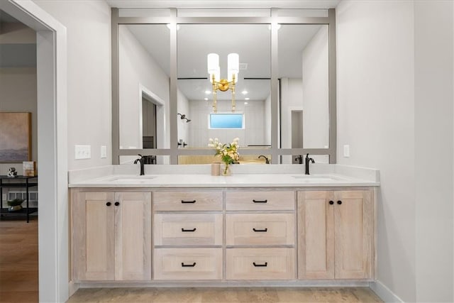 8720 N Lewis Ave, Kansas City, MO 64157 - bathroom featuring double vanity, a chandelier, and baseboards