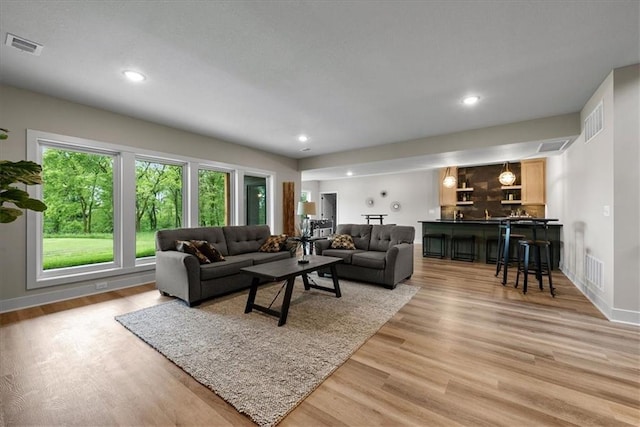 8720 N Lewis Ave, Kansas City, MO 64157 - living room with wet bar, light wood-type flooring, recessed lighting, and baseboards