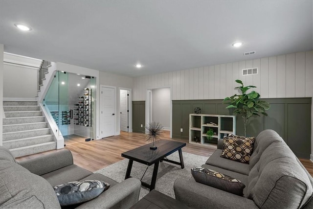 8720 N Lewis Ave, Kansas City, MO 64157 - living area with a decorative wall, stairs, light wood-type flooring, and recessed lighting