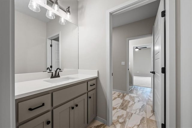 8720 N Lewis Ave, Kansas City, MO 64157 - bathroom with marble look tile flooring, vanity, baseboards, and a ceiling fan