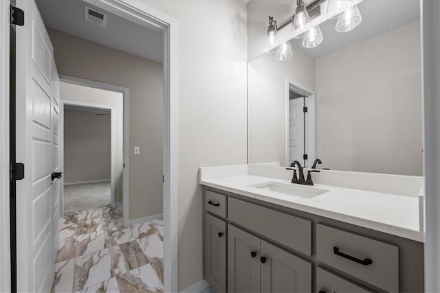 8720 N Lewis Ave, Kansas City, MO 64157 - bathroom featuring marble finish floors, vanity, and baseboards