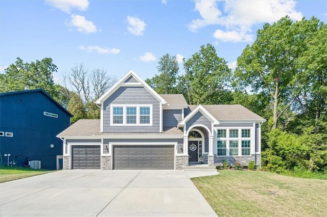 craftsman-style house featuring a garage and a front yard