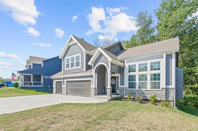 craftsman house with a front yard and a garage