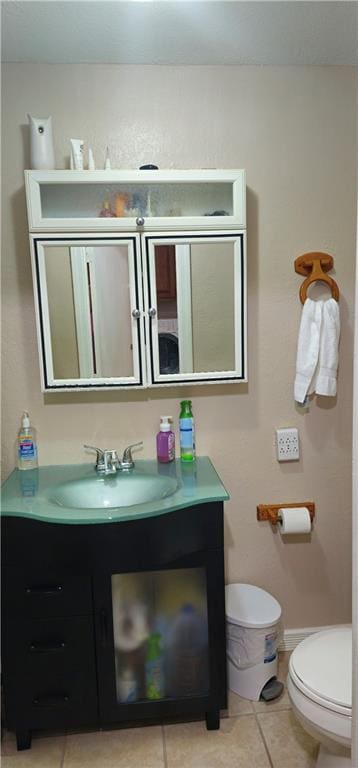 bathroom with tile patterned floors, toilet, and vanity