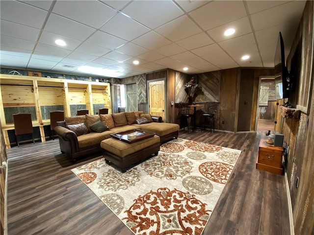 411 5th St, Mccune, KS 66753 - living room with wooden walls, a drop ceiling, and wood finished floors