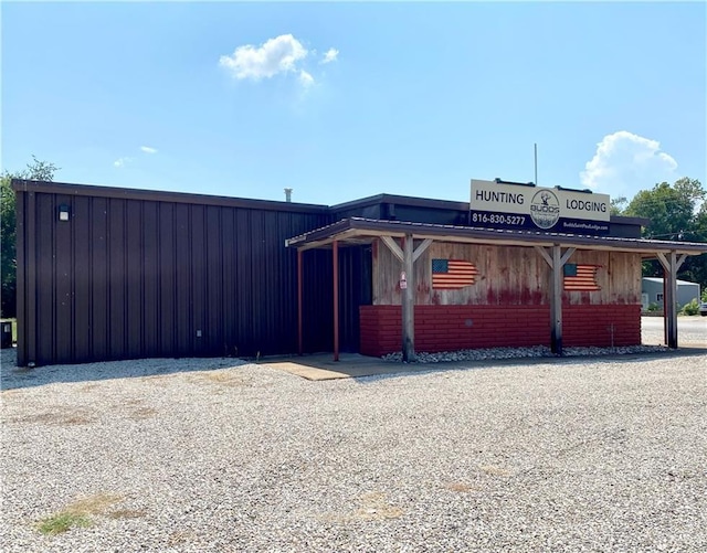 411 5th St, Mccune, KS 66753 - exterior space featuring board and batten siding