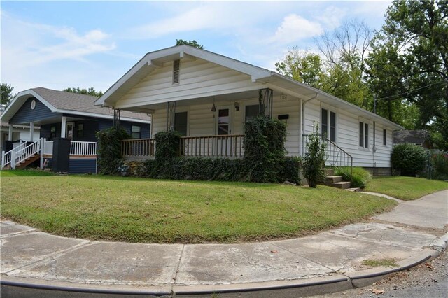 view of front of house with a front lawn and covered porch