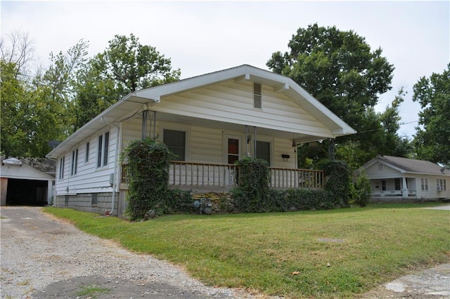 bungalow-style house with a front lawn and a porch