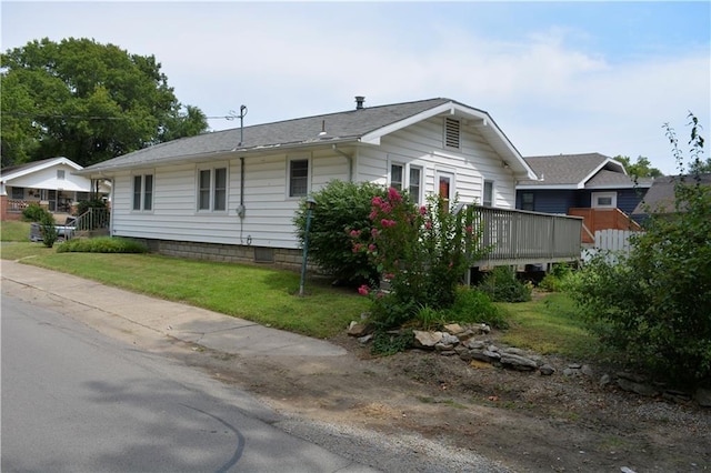 exterior space featuring a front yard and a deck