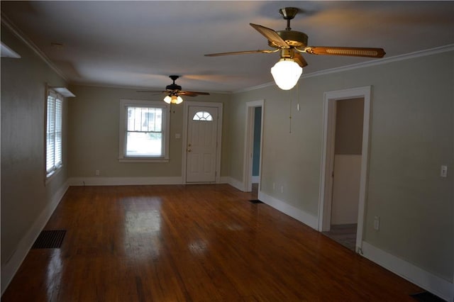 entrance foyer with visible vents, baseboards, crown molding, and wood finished floors