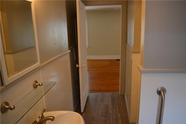 bathroom featuring baseboards and wood finished floors