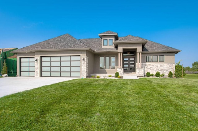 5163 NW 47th Ter, Riverside, MO 64150 - prairie-style home featuring a garage, stone siding, french doors, stucco siding, and a front lawn