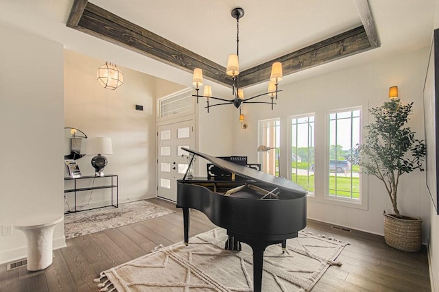 living area with baseboards, visible vents, and hardwood / wood-style floors