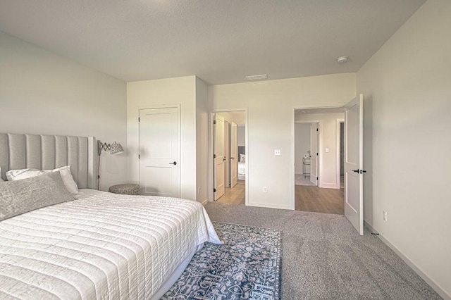 carpeted bedroom with baseboards and visible vents